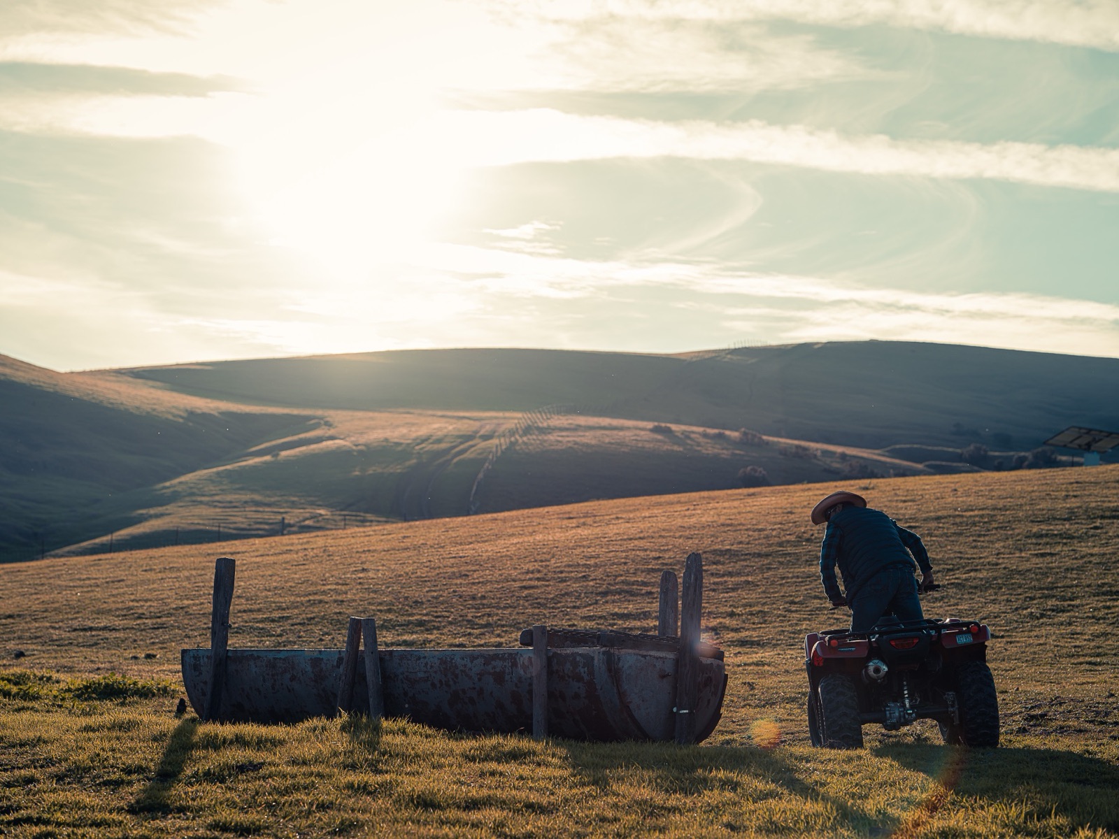 Gaspar riding out to check the trough at golden hour