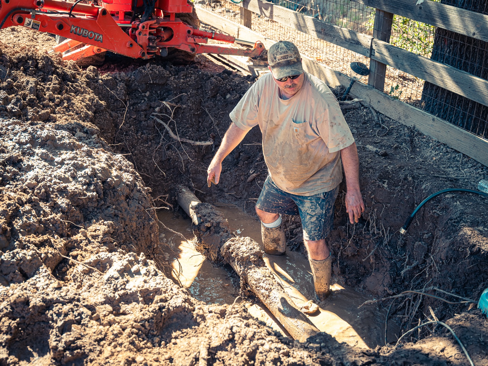Scott repairing a water line leak in the mud